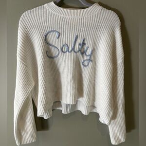 White knit pullover sweater with wide sleeves.